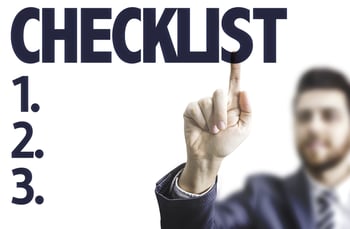Business man pointing the text Checklist-1