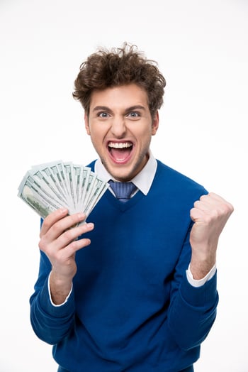 Happy businessman holding money over gray background