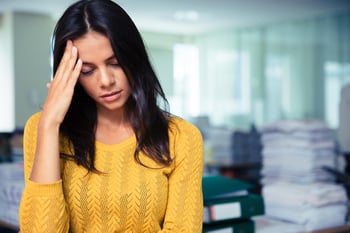 Portrait of a tired casual businesswoman standing in office-1