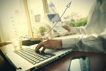 business documents on office table with smart phone and digital tablet and graph business diagram and man working in the background-1